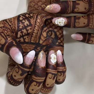 My signature bridal look, featuring a soft ombré, gold glitter, and hand-sculpted 3D flowers. This design is crafted to harmonize beautifully with detailed bridal henna.
