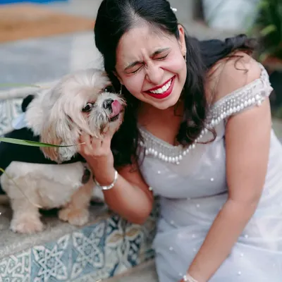 Pure, unscripted joy. Including your furry family members in your shoot is always a great idea, and it often leads to the most genuine and heartwarming moments, like this puppy kiss.
