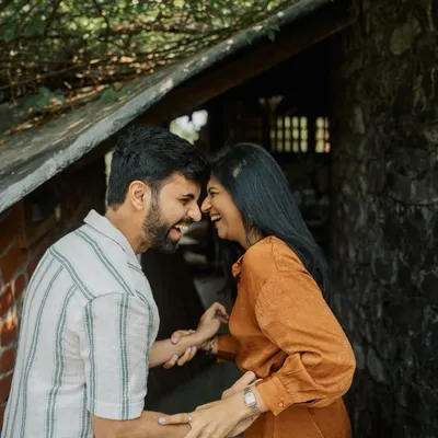 A moment of shared laughter in a rustic, earthy setting. This is the kind of natural, unforced joy I love to capture in my pre-wedding couple portraits.