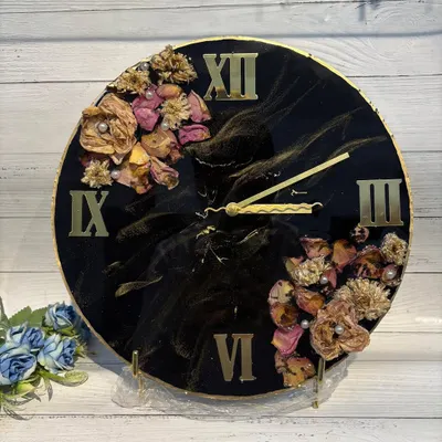 This handcrafted resin clock features a dramatic black and gold design. I've preserved flowers in a crescent shape, creating a bold and elegant statement piece for your wall.