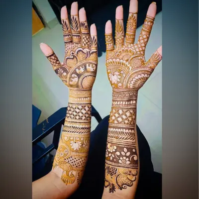 A classic full-arm Indian mehandi design, featuring elephant and peacock motifs, paisleys, and geometric bands for a rich, celebratory look.