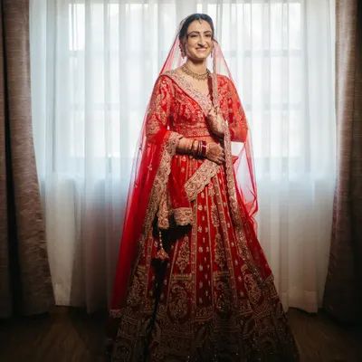 The classic red lehenga, the gentle smile, the quiet anticipation. I believe in capturing the timeless grace of a bride. This is more than a photo; it's an heirloom, a memory of the moment you stood on the threshold of forever.