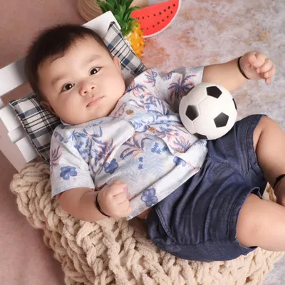 This six-month-old sitter was an absolute star during his beach-themed studio session. His relaxed pose and sweet expression perfectly capture the calm and happy nature of this milestone age.