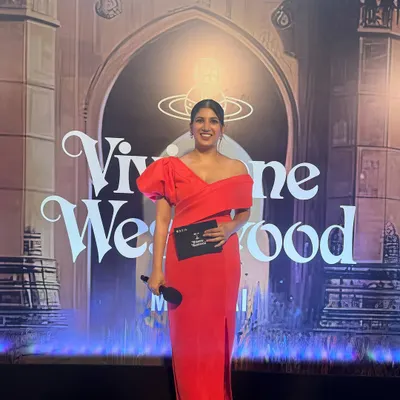 Dressed in a striking red gown, ready to host the Vivienne Westwood Mumbai event. For fashion and lifestyle brands, I bring a glamorous and energetic presence that complements the brand's image.