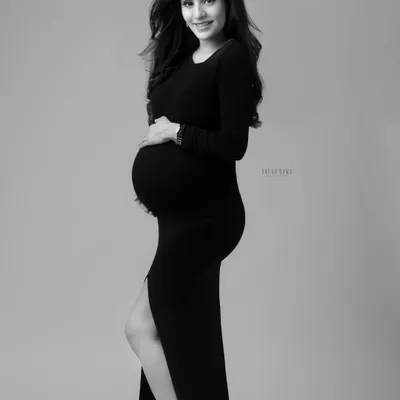 A classic solo portrait in black and white. The simplicity of a form-fitting black dress and clean background creates a sophisticated and timeless image that focuses on your silhouette.