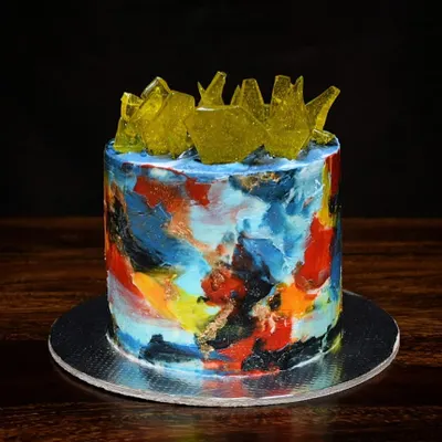This cake is like an edible canvas. I used a palette knife with different colored buttercream to create this abstract, textured art piece, topped with shards of yellow sugar glass for a modern look.