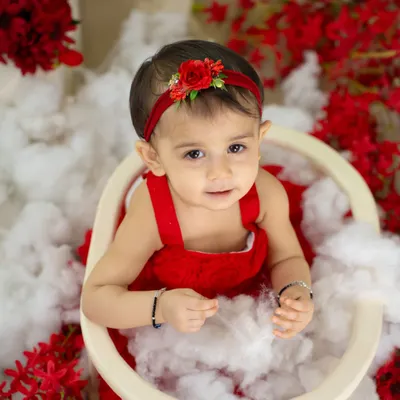 A beautiful, simple portrait of a little girl in red. Her direct gaze and sweet expression are the focus of this lovely shot.