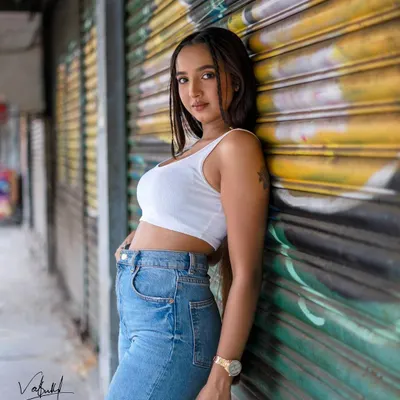 Using the vibrant colors of a graffiti-covered wall as our canvas. This street fashion shot has a bold, artistic energy that perfectly matches the model's confident pose.