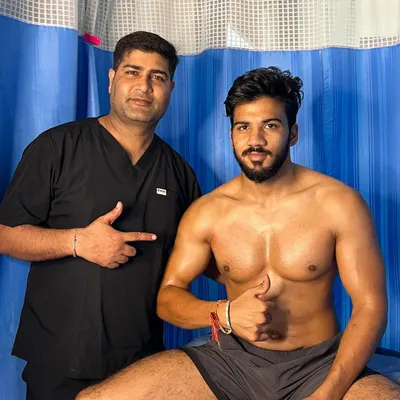 A happy client giving a thumbs-up after his muscle recovery session.