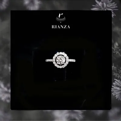 Our most popular design, this is a timeless round brilliant solitaire set in a delicate halo of smaller diamonds. It is a classic and elegant choice for an engagement ring.