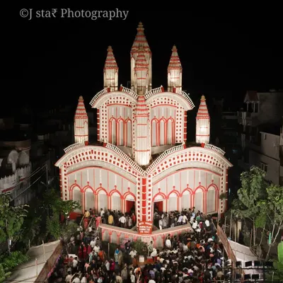 The beauty of Durga Puja is in the details. This is a low-altitude shot of a pandal in Prayagraj, designed with classic red and white Bengali patterns. I make sure to capture the energy of the crowd gathered for darshan.