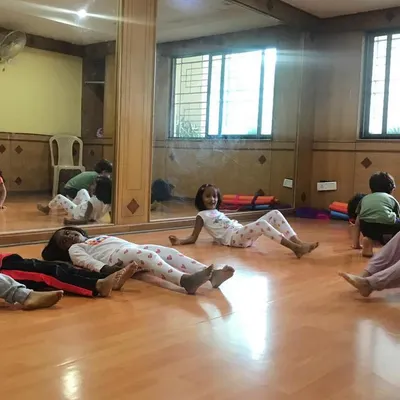 A look at our outdoor program, where we bring "Serious Fun" right to your apartment's doorstep. These images show kids enjoying gymnastics and yoga on mats in both indoor and outdoor community spaces.