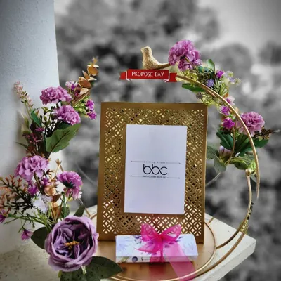 A perfect gift to commemorate a special proposal. This exquisite cutwork photo frame is set within a floral hoop, creating a beautiful display piece for an engagement, anniversary, or Valentine's Day.
