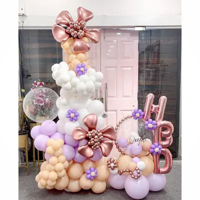 This organic balloon column showcases our signature floral elements. We created intricate, multi-layered flowers from balloons and integrated them into a pastel-colored column, perfect as a standalone display or entrance piece.
