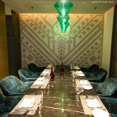 Our exclusive private dining room at Zodiac, featuring plush velvet chairs and elegant green glass chandeliers, is the perfect venue for your next intimate gathering.