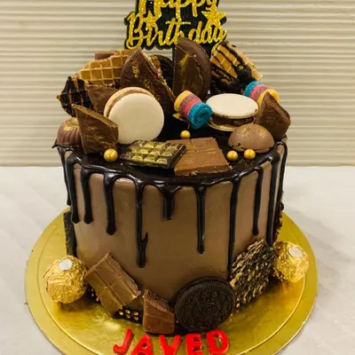 Drooling over this! A chocolate truffle cake overloaded with a variety of treats including macarons, Oreos, wafers, and different kinds of chocolates.
