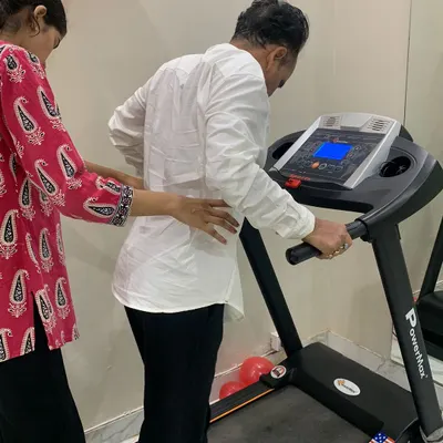 Supervised treadmill walking is an excellent way to improve cardiovascular health and gait pattern. I am providing support to ensure proper posture and safety, helping this patient build stamina and walking confidence step by step.