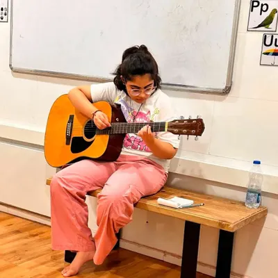 A young guitarist lost in her music during a class at our new Borivali branch. We provide a comfortable space for students to practice and grow.