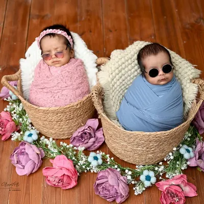 Too cool for school. These twin newborns are rocking tiny sunglasses in their individual baskets, showing off their personalities even at this early age.