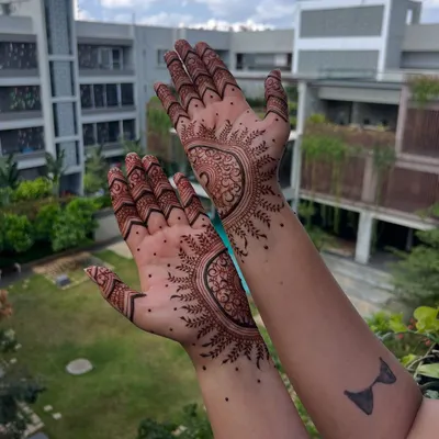 A side view of this intricate mandala design, showing how the pattern extends to the wrist. The shading and line work create a beautiful, three-dimensional effect.