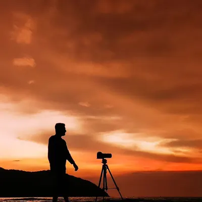 A silhouette of me with my camera on a tripod against a beautiful sunset on the beach. This image represents my identity as a filmmaker, always in search of the perfect light and moment.