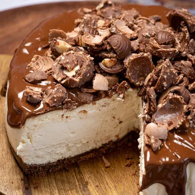 A perfect slice of my Nutella Ferrero Cheesecake. The creamy, smooth cheesecake filling sits on a chocolate biscuit base and is topped with a generous layer of Nutella and crushed Ferrero Rocher.
