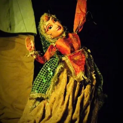 A close-up of a female dancer puppet, a classic character in Kathputli performances. The details in her sequined dress and the delicate painting of her face are all done by hand to capture the traditional Rajasthani style.