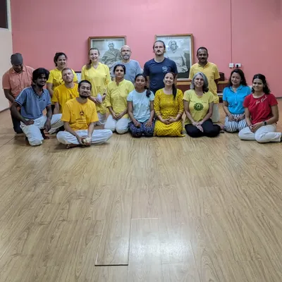 When you join our course, you become part of a global family. This is a photo of our dedicated staff and teachers at the Sivananda South Delhi center. We are here to support your growth and welcome you into our vibrant yoga community.