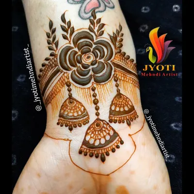 A beautiful and creative wrist cuff design featuring a large flower with dangling jhumka (earring) motifs. This jewelry-inspired piece is a unique and stylish choice.