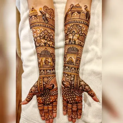 A full bridal design telling a royal story. This piece includes scenes from a wedding procession, with elephants, palaces, and doli motifs covering the hands and arms.