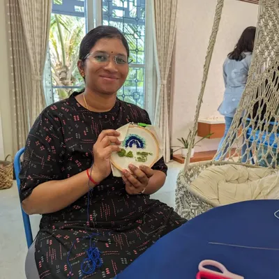 A happy participant showing off her completed rainbow and cloud artwork. It’s amazing what you can create in just a few hours.