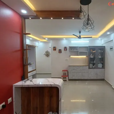 A vibrant living area brought to life with a bold red accent wall and crisp white surroundings. We specialize in creating modern, clean looks that combine flawless painting with strategic lighting and design to make your home feel brand new.