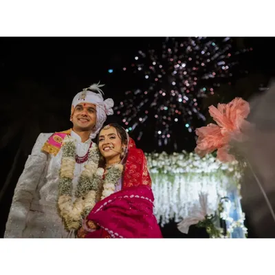 A stunning shot of the couple under a burst of fireworks, marking a magical end to their wedding day.