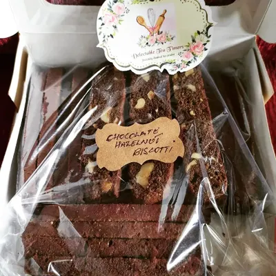 A freshly packed batch of our Chocolate Hazelnut Biscotti. You can see the generous chunks of hazelnut in each slice, all handmade by our BakeStar from Delectable Tea Timers in Andheri West.