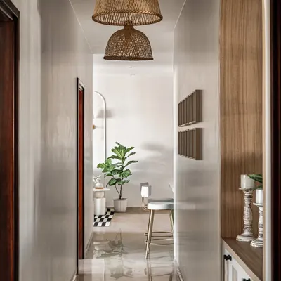This hallway design is a perfect blend of style and function. The white walls and pendant lights create a bright and inviting path, while the plants add a touch of nature.