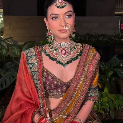 A full-length view of this gorgeous bridal look. The multi-hued lehenga is perfectly complemented by the intricate Kundan choker set, creating a timeless and regal final shot for any portfolio.