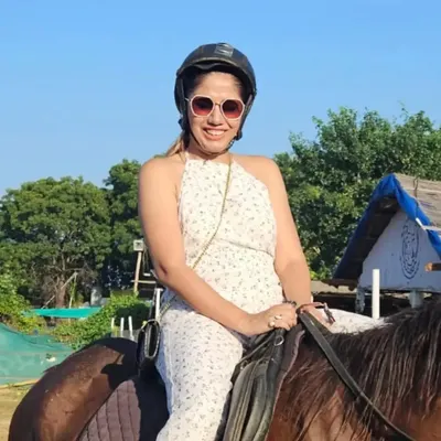 A smiling rider enjoying her safari experience. Our trails provide a beautiful backdrop for creating happy and memorable moments, perfect for a special day out.