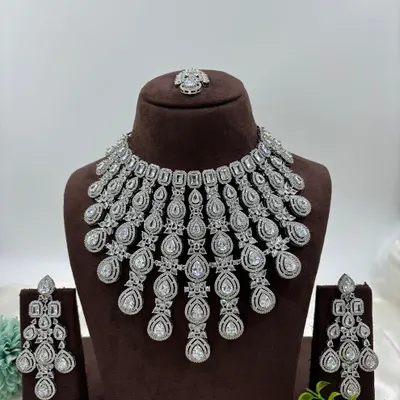 A grand, cascading necklace made with brilliant-cut American Diamonds. This is a showstopper piece, perfect for a reception gown or a modern saree.