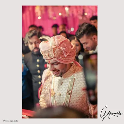 A candid shot of the groom's entry, his happy smile capturing the excitement of the moment.
