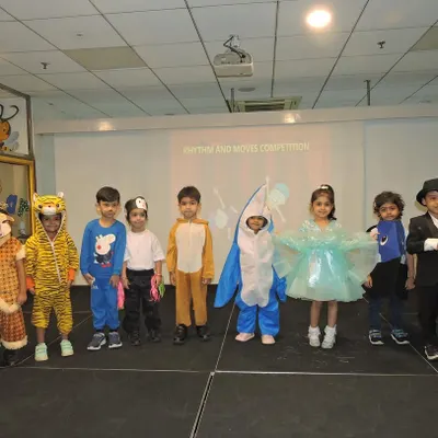 Our little performers line up in their vibrant costumes after the 'Rhythm and Moves' dance competition, each one a star on our stage.