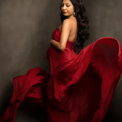 The magic of a single piece of fabric. We use silks like this to create a sense of movement and drama, turning a simple portrait into a work of art. This flowing red is a studio favorite.