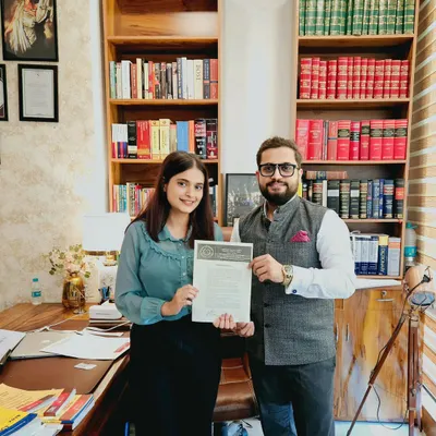 Presenting a certificate of completion to Ms. Aayushi from ICFAI Law School Dehradun. Our internship program provides hands-on experience in real-world legal cases.