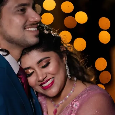 A close up, intimate moment between a couple at their reception. We use the warm glow of the background lights to create a romantic and dreamy feel.