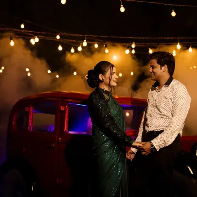 I create stunning cinematic night shoots using professional lighting, atmospheric smoke, and props like this vintage car. This style is perfect for couples wanting dramatic and romantic pre-wedding portraits.