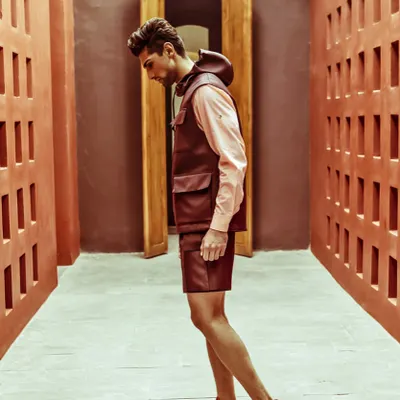 A throwback to an editorial series for The Man magazine. This look features a leather utility vest and shorts from Dior, showcasing a high-fashion, utilitarian aesthetic.