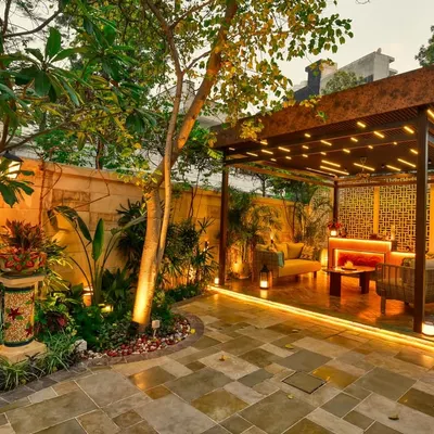 This backyard is now a stunning retreat for relaxation and entertainment. The custom pergola with integrated lighting creates a warm and inviting lounge area, while the surrounding greenery and stone pathways complete the sanctuary feel.
