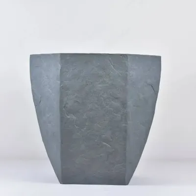 A modern, hexagonal fiber planter with a stone-like finish. These are lightweight, durable, and perfect for both indoor and outdoor use.