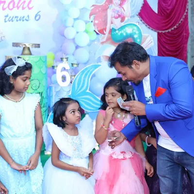Performing a little close-up magic for the kids at a birthday party. It's always a joy to see their amazed faces and make the event more magical for them.