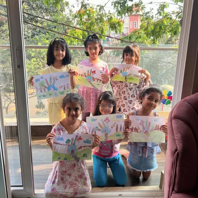 Look at this amazing group of artists! They are all so proud to show off the imaginative houses they created from a simple hand outline.