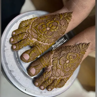 A close-up of a floral design on the feet, with delicate details covering the toes and top of the foot.